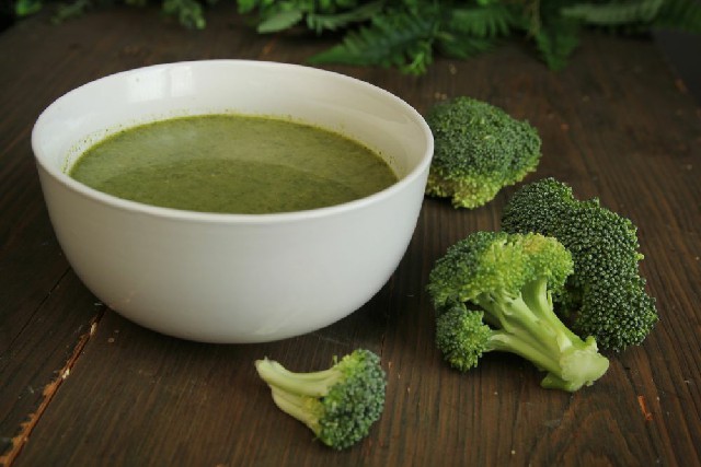 broccoli almond soup in white color bowl.