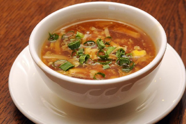 veg manchow soup in white color bowl.