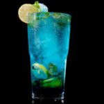 blue virgin mojito in glass with lemon slice.