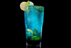 blue virgin mojito in glass with lemon slice.