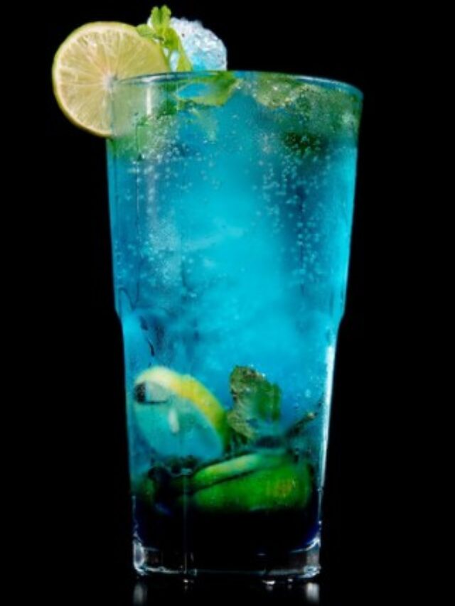 blue virgin mojito in glass with lemon slice.
