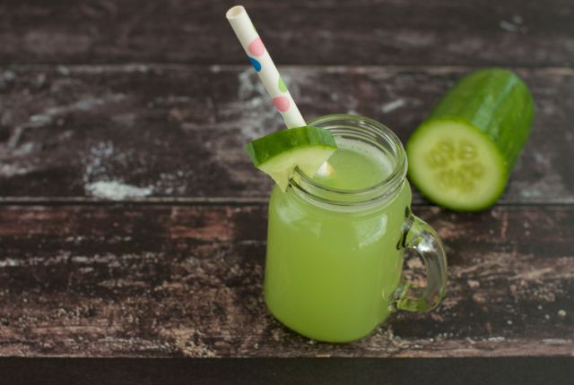 cucumber juice in jar with straw.