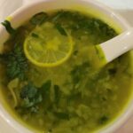 lemon coriander soup in white bowl.