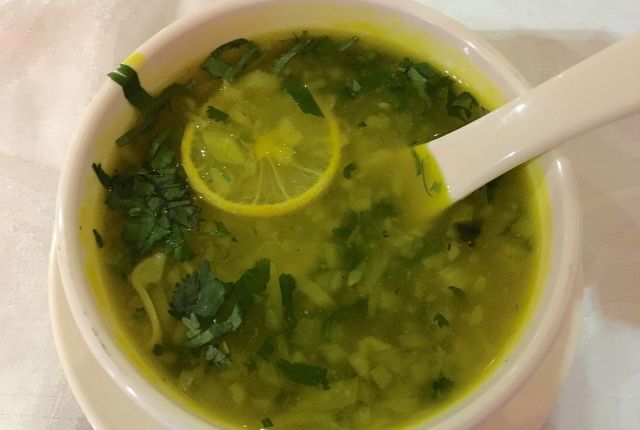 lemon coriander soup in white bowl.