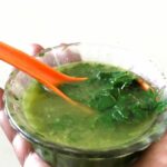 moringa soup in bowl with spoon.