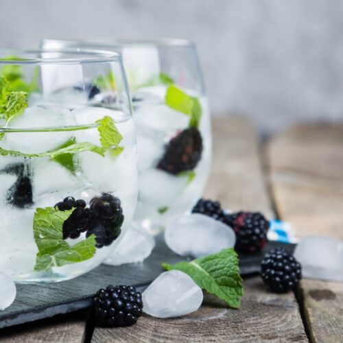 blackberry mojito in glass with ice cubes.
