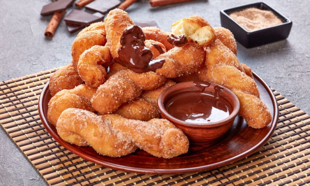 kkwabaegi or korean doughnuts in plate with dip bowl,