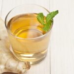 korean ginger tea in glass, ginger on the tableware.