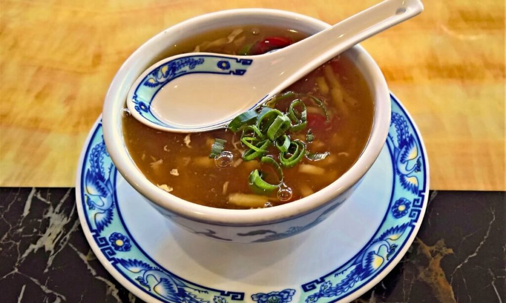 veg peking soup in white color bowl.