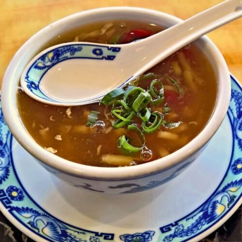 veg peking soup in white color bowl.